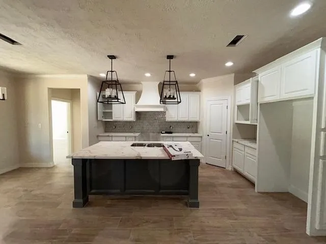 a kitchen with a sink appliances and cabinets