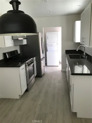 a kitchen with a stove and a refrigerator