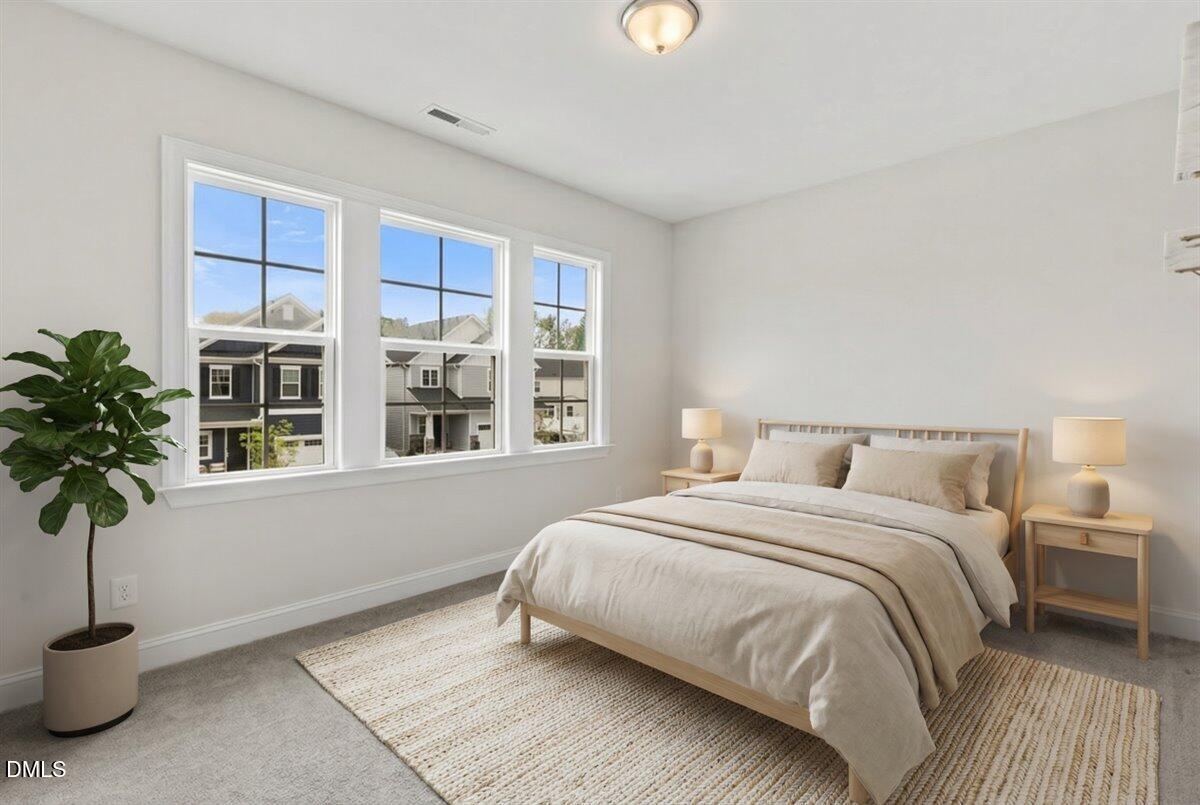 4937 Abundance Avenue Raleigh, NC 27616 - Photo 25 of 36 a bedroom with a bed and a potted plant