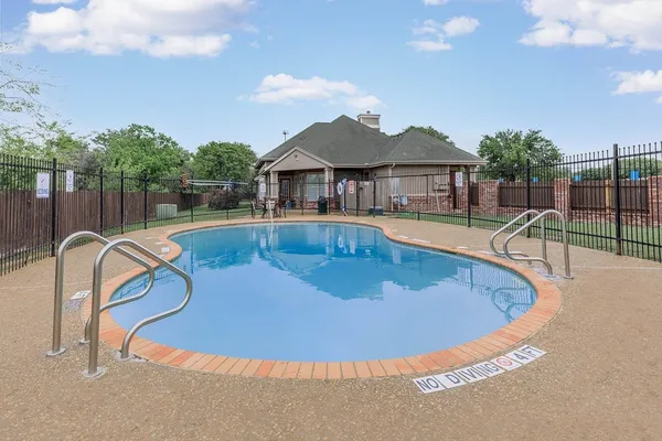 a view of a house with swimming pool and sitting area