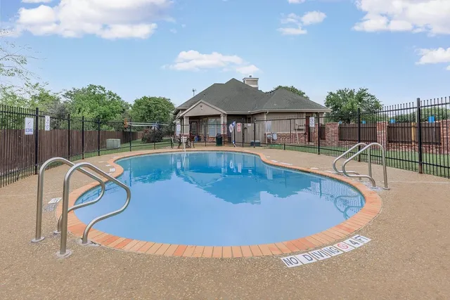 a view of a house with swimming pool and sitting area