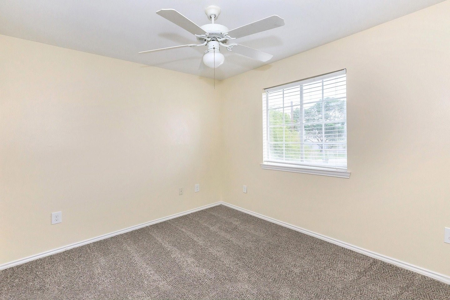 9257 Somerset Road San Antonio, TX 78211 - Photo 15 of 18 an empty room with windows and ceiling fan