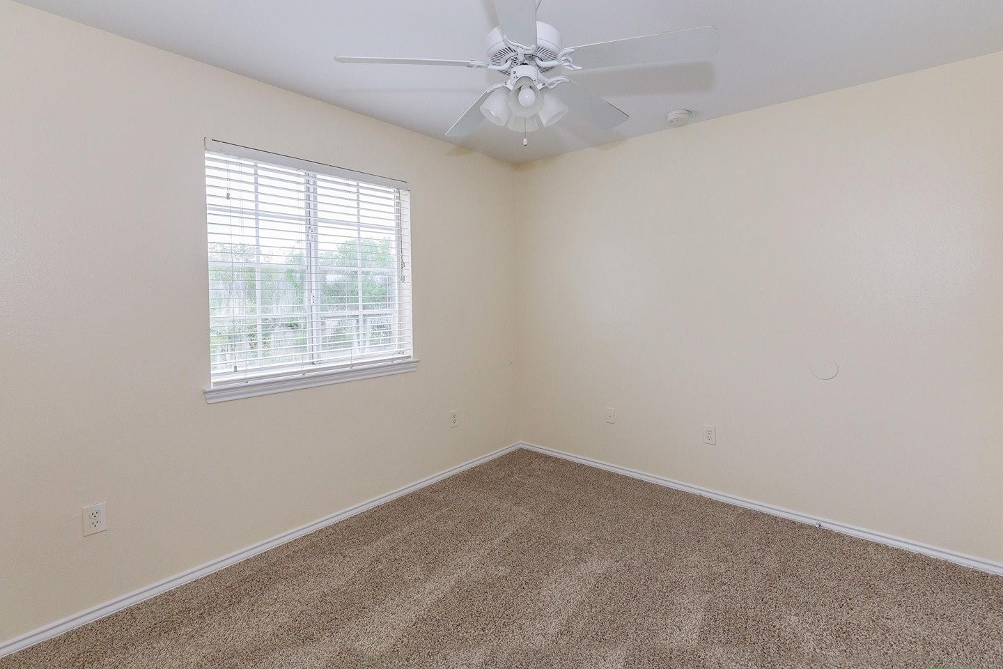 9257 Somerset Road San Antonio, TX 78211 - Photo 17 of 18 an empty room with a window and ceiling fan
