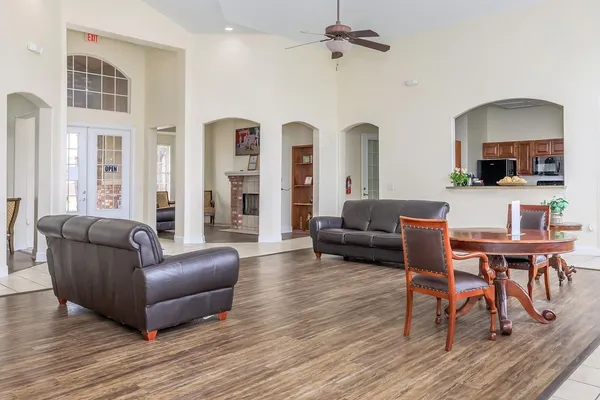 a living room with furniture and a wooden floor