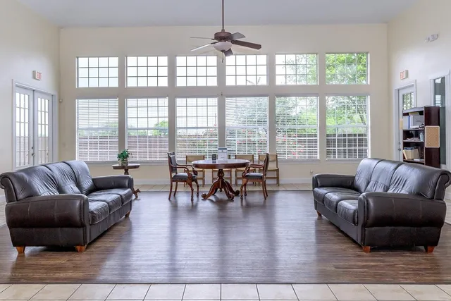 a living room with furniture and a large window
