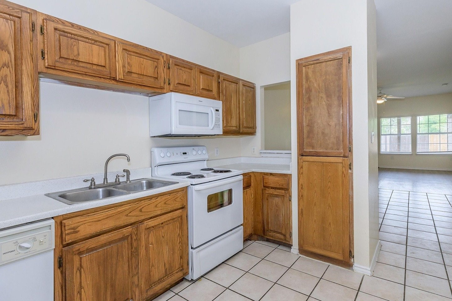 9257 Somerset Road San Antonio, TX 78211 - Photo 10 of 18 a kitchen with stainless steel appliances granite countertop a stove a sink and a refrigerator
