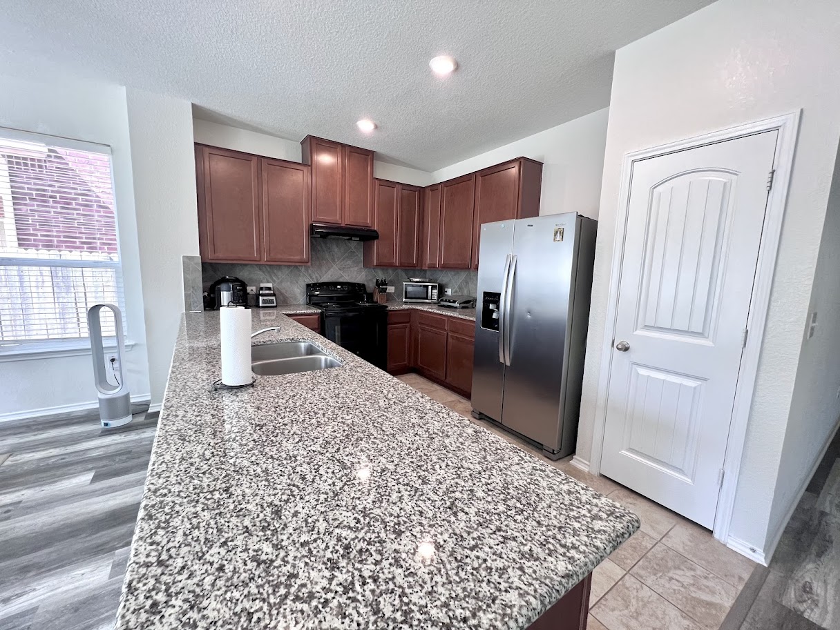 7900 Crystalbrook West Austin, TX 78724 - Photo 16 of 27 a kitchen with stainless steel appliances granite countertop a refrigerator sink and cabinets