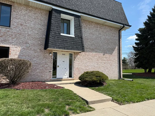 a view of a house with a yard and a garden