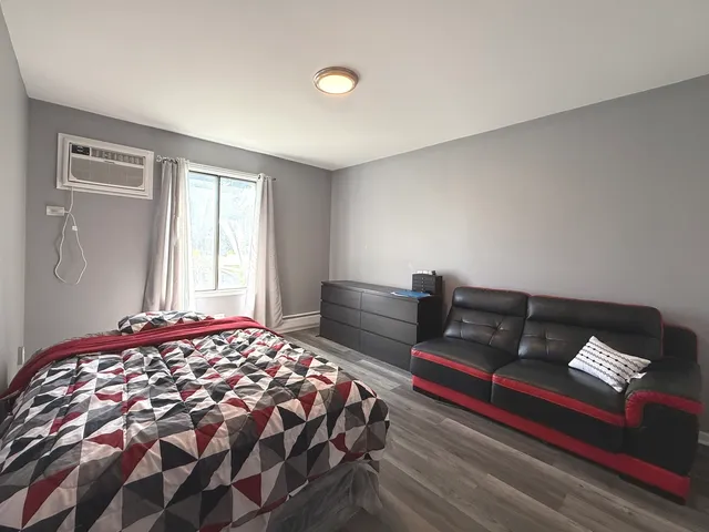 a bedroom with a bed and window