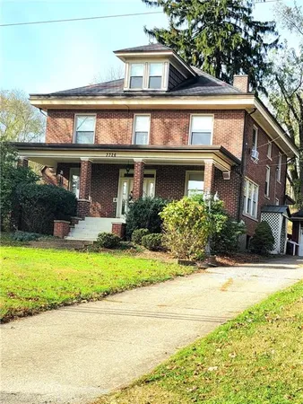 a view of a house with a yard and plants