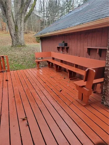 a backyard of a house with barbeque oven and outdoor seating