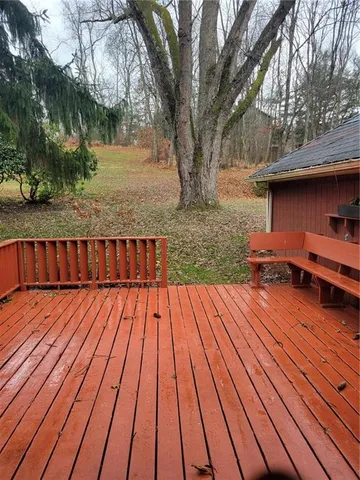 a view of backyard with wooden floor and outdoor seating