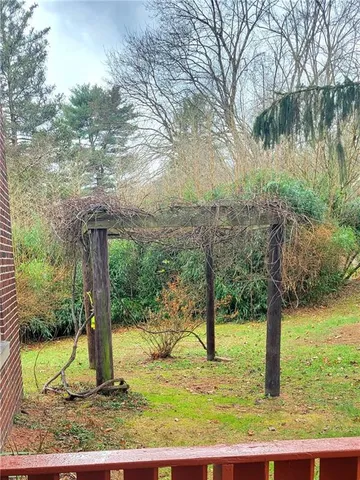 a backyard of a house with a yard and outdoor seating