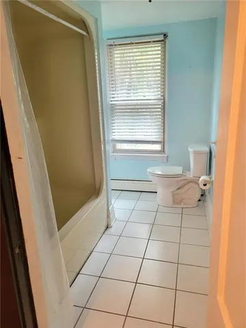 a bathroom with a toilet a sink and a shower