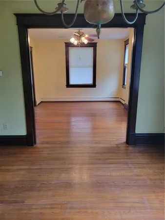 a view of a room with wooden floor