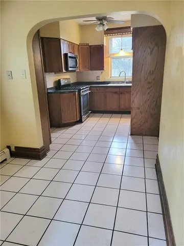 a kitchen with stainless steel appliances granite countertop a refrigerator and a stove