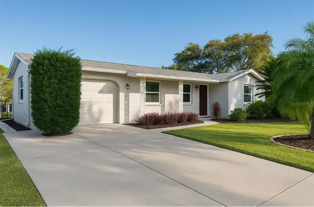 a front view of house with yard and green space