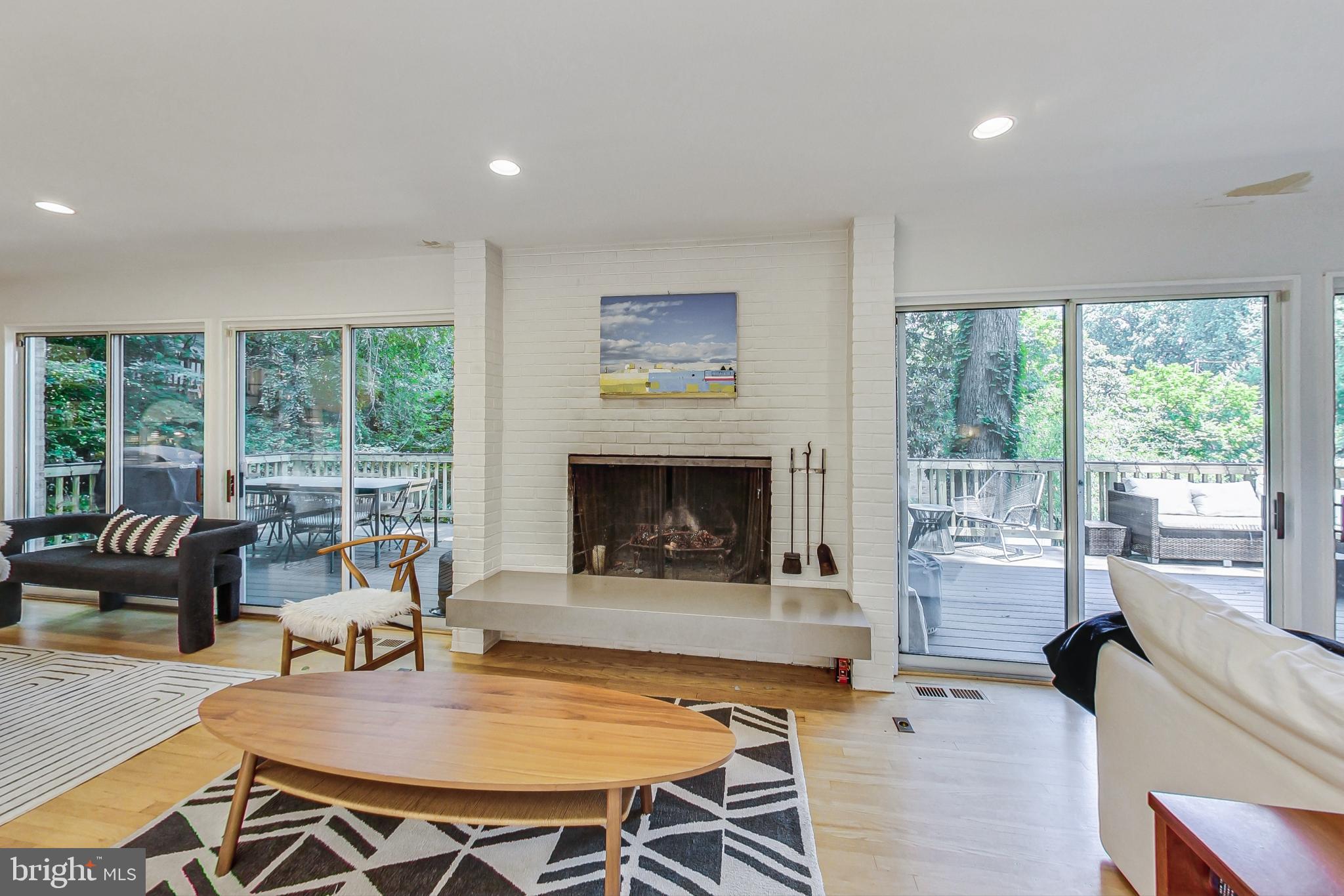 1205 Dale Drive Silver Spring, MD 20910 - Photo 5 of 46 Fireplace flanked by sliding glass doors