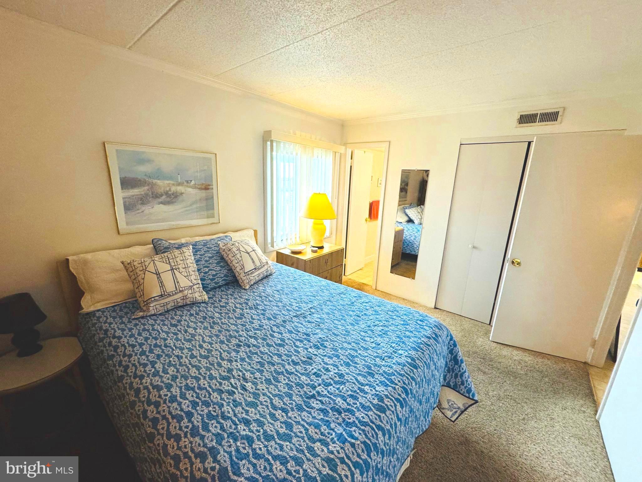 2 80th Street, Unit 212 Ocean City, MD 21842 - Photo 12 of 27 a large bed sitting in a bedroom next to a window