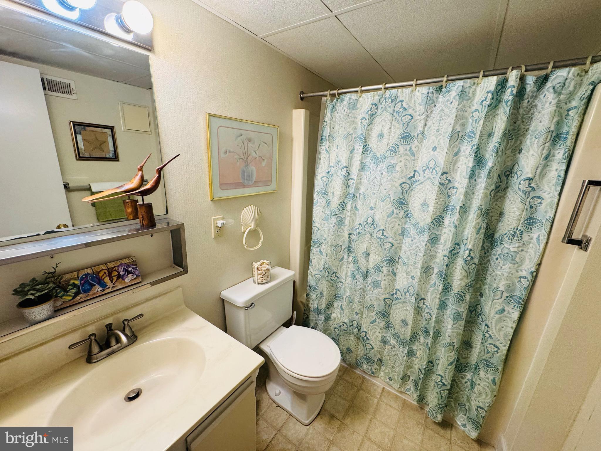 2 80th Street, Unit 212 Ocean City, MD 21842 - Photo 21 of 27 a white toilet sitting next to a bathroom sink