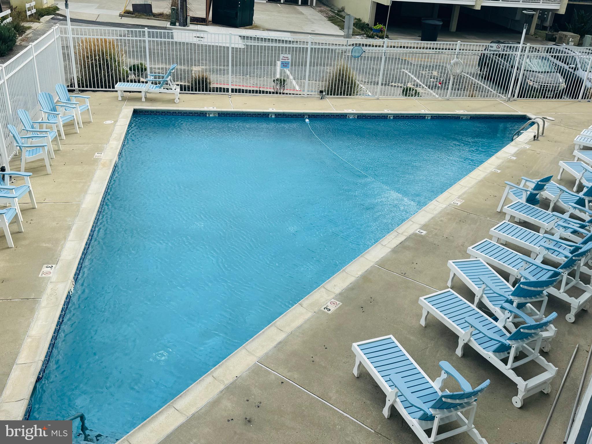 2 80th Street, Unit 212 Ocean City, MD 21842 - Photo 24 of 27 a view of balcony with a table and chairs