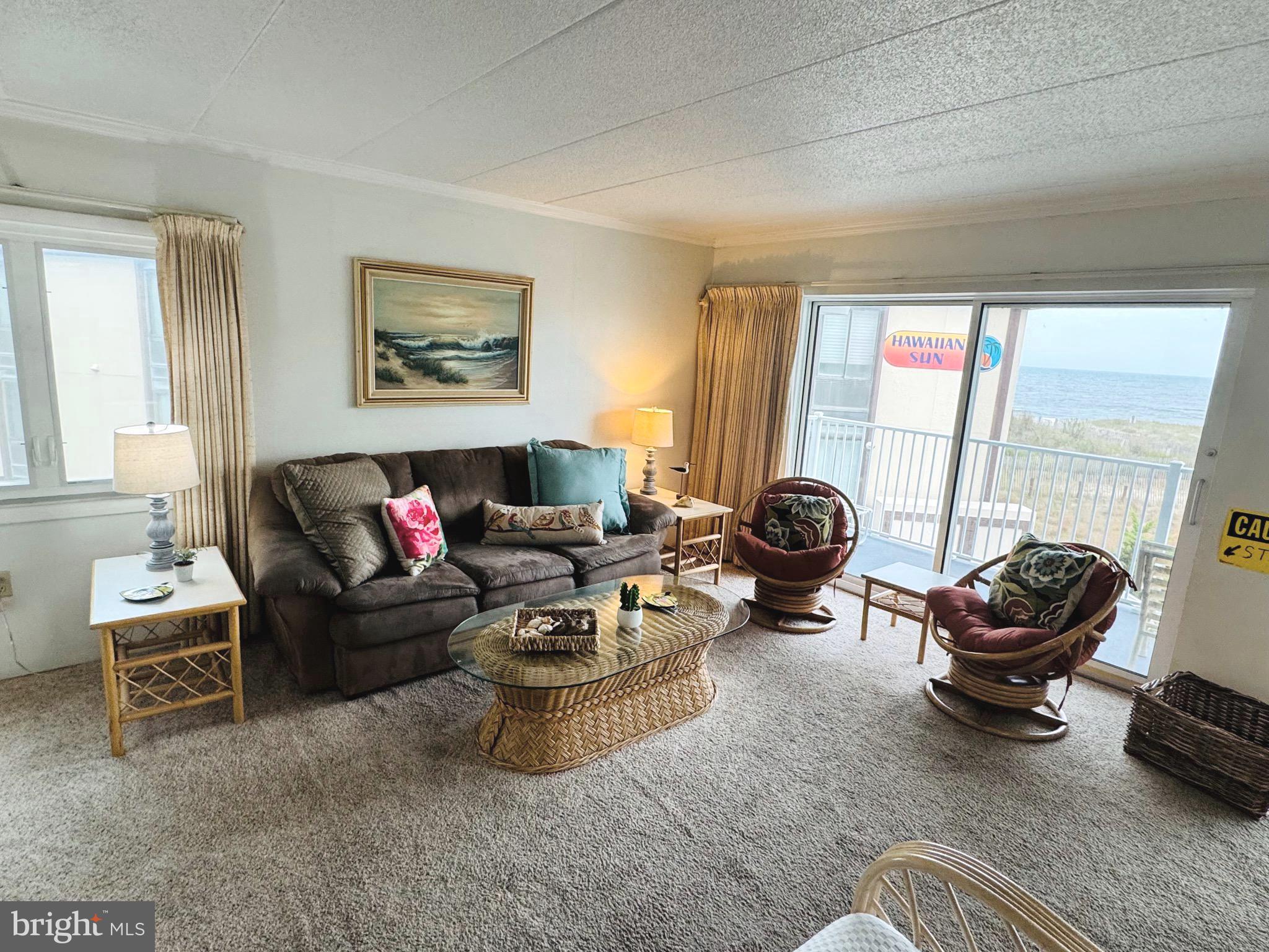 2 80th Street, Unit 212 Ocean City, MD 21842 - Photo 5 of 27 a living room with furniture a rug and a large window