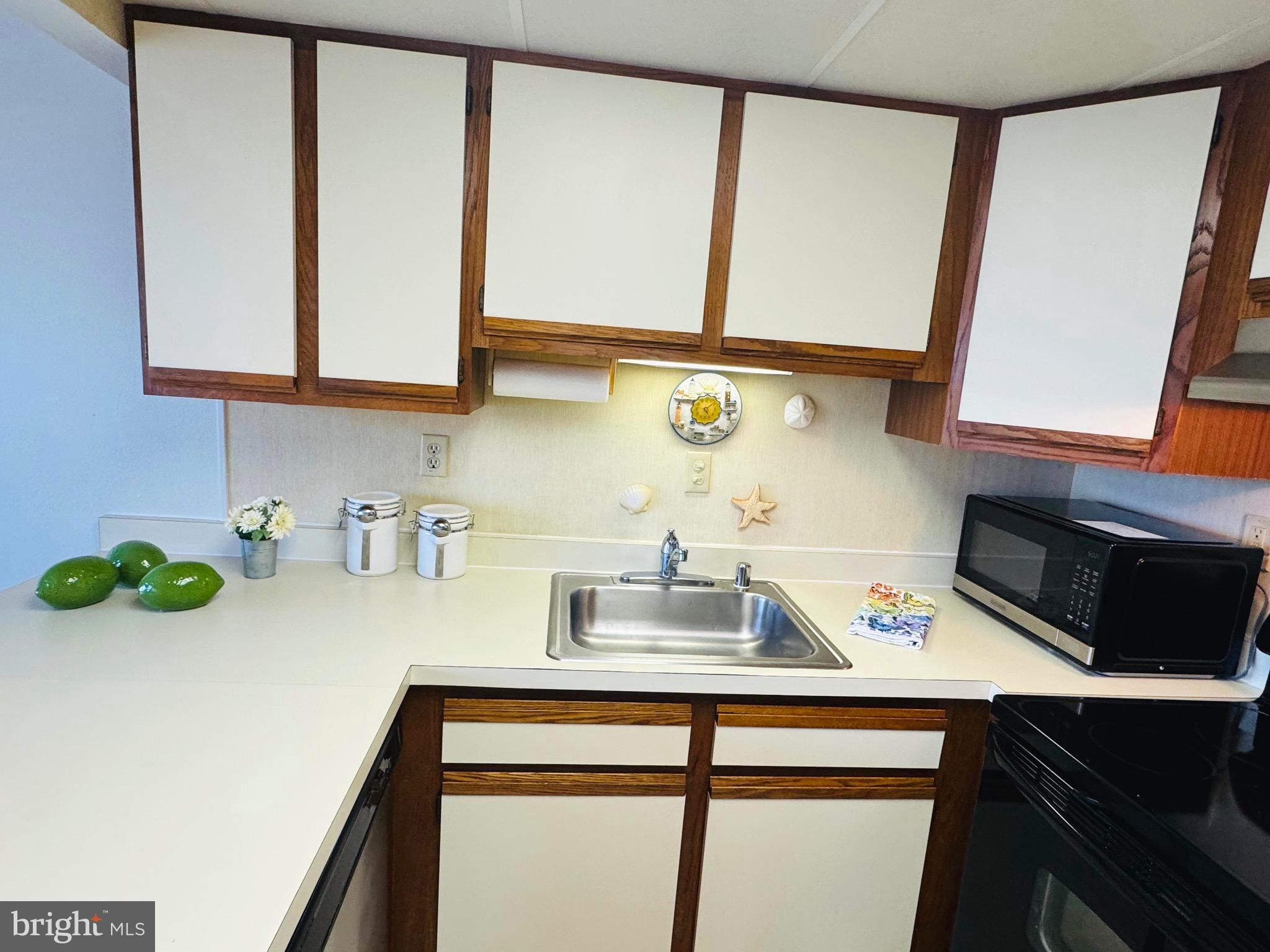 2 80th Street, Unit 212 Ocean City, MD 21842 - Photo 10 of 27 a kitchen with a sink cabinets and a window