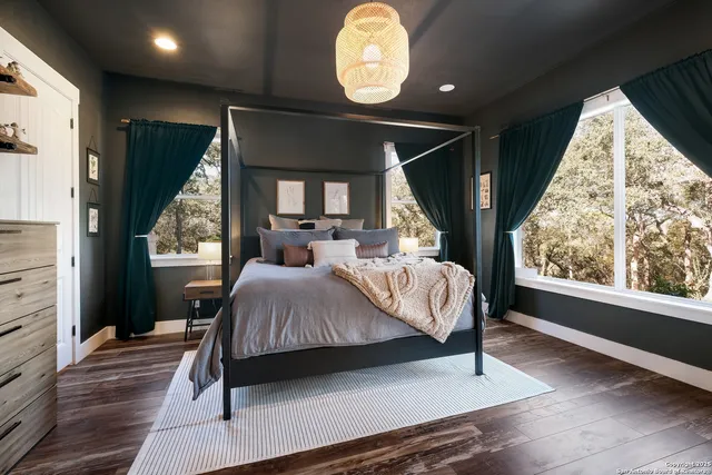 a bedroom with a large bed and a large window