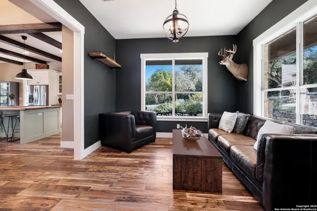 a living room with furniture and a large window