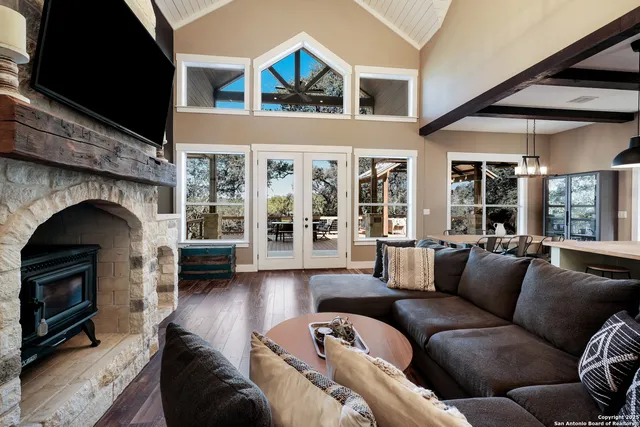 a living room with furniture a fireplace and a flat screen tv