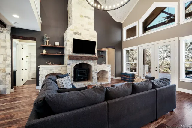 a living room with furniture a fireplace and a flat screen tv