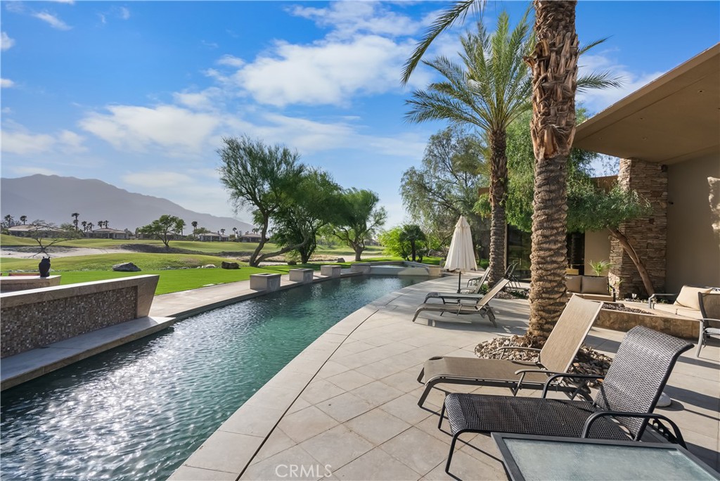 68 Royal St Georges Way Rancho Mirage, CA 92270 - Photo 11 of 75 a view of swimming pool with lounge chair and lake view
