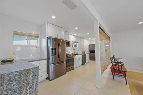 a kitchen with stainless steel appliances a refrigerator and a stove