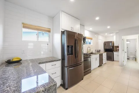 a kitchen with a sink stove and refrigerator