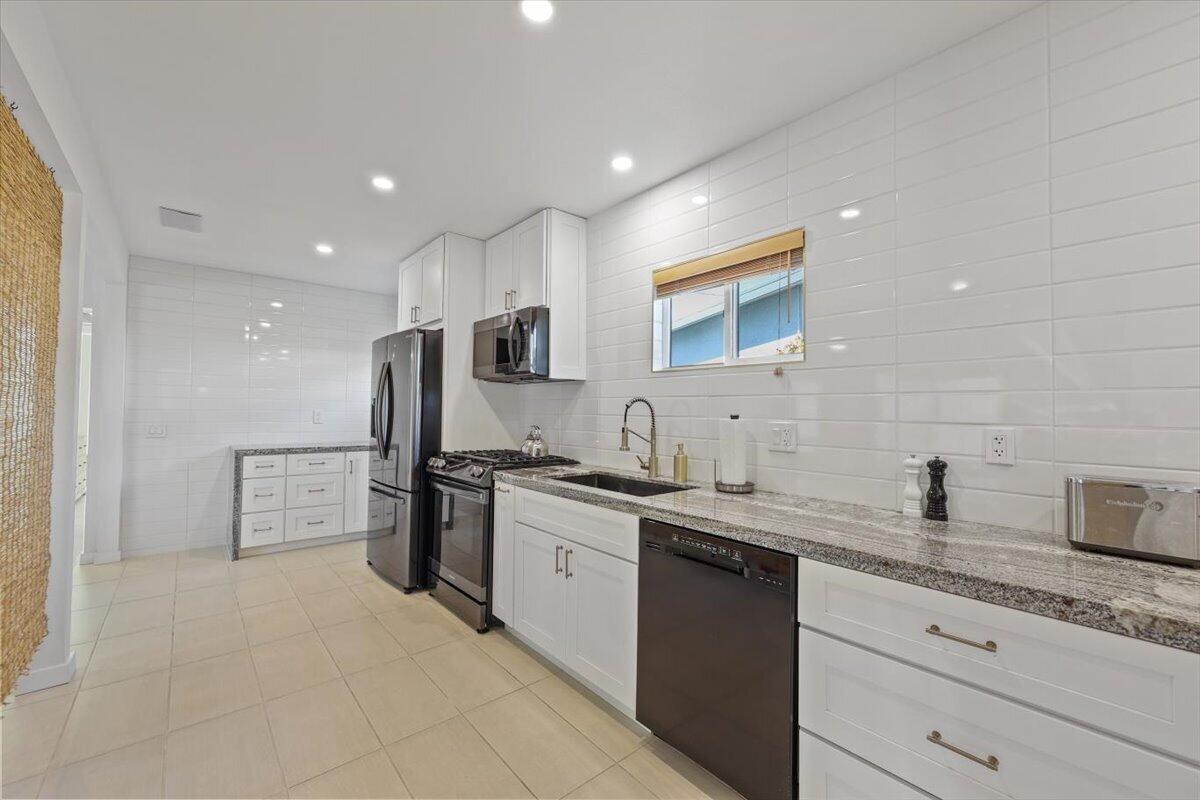 3991 Calle San Raphael Palm Springs, CA 92264 - Photo 13 of 45 a kitchen with a sink stove and refrigerator