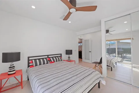 a bedroom with a bed and a ceiling fan