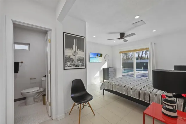 a bedroom with a large bed and a large window