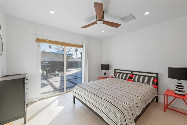 a bedroom with a bed and a table with projector