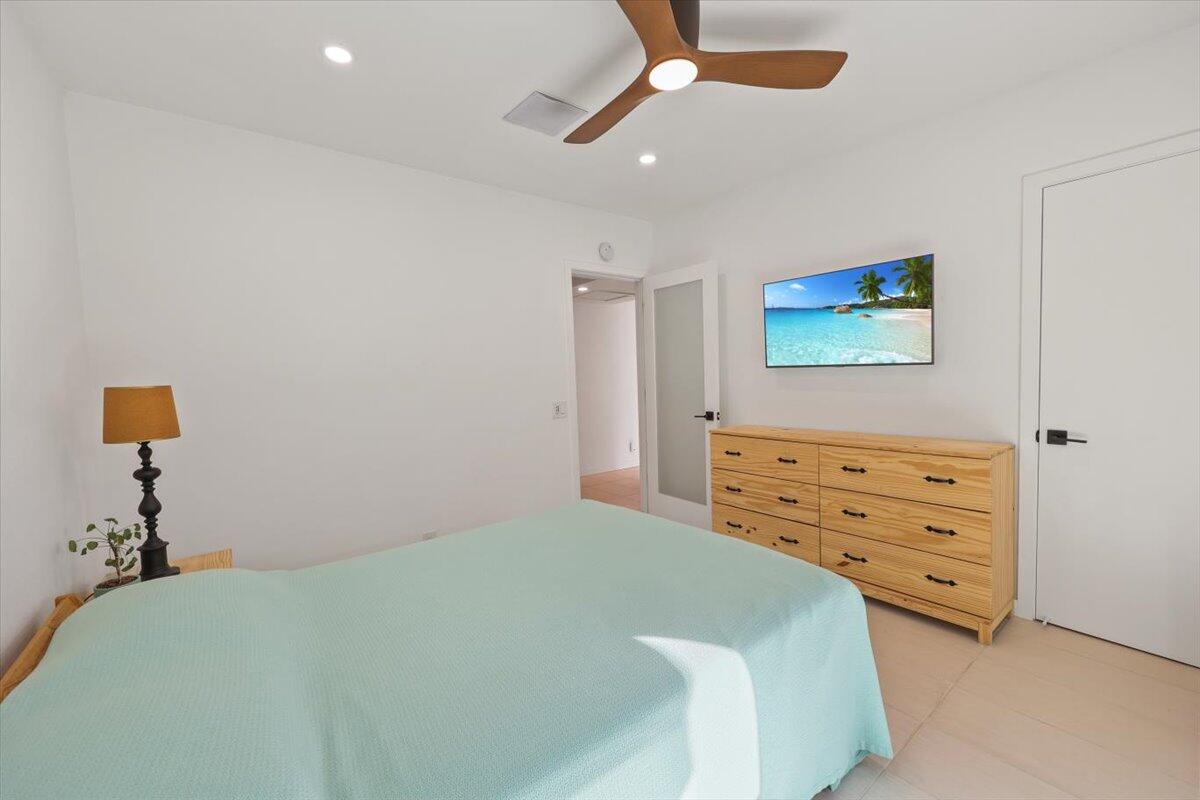 3991 Calle San Raphael Palm Springs, CA 92264 - Photo 20 of 45 a bedroom with a bed and a chandelier