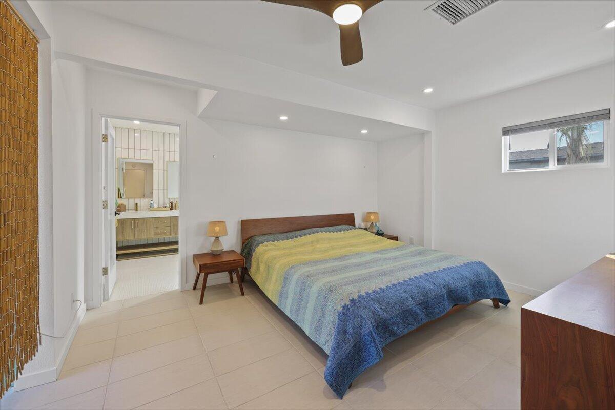 3991 Calle San Raphael Palm Springs, CA 92264 - Photo 22 of 45 a bedroom with a bed and a lamp on desk