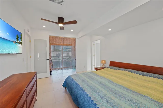 a bedroom with a bed and a ceiling fan