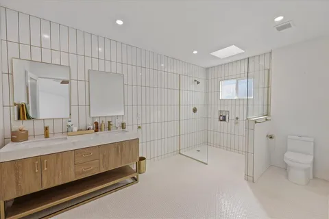 a bathroom with a tub a sink and a shower