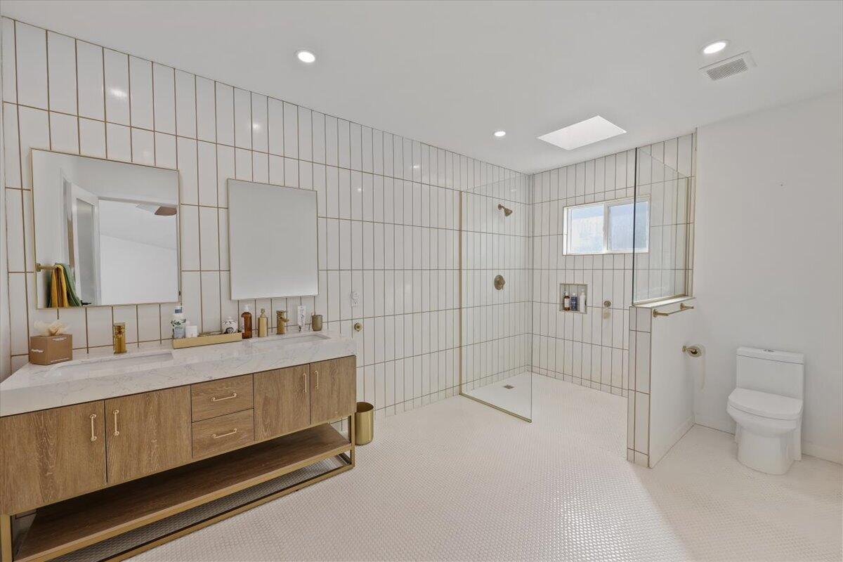 3991 Calle San Raphael Palm Springs, CA 92264 - Photo 26 of 45 a bathroom with a double vanity sink toilet and shower