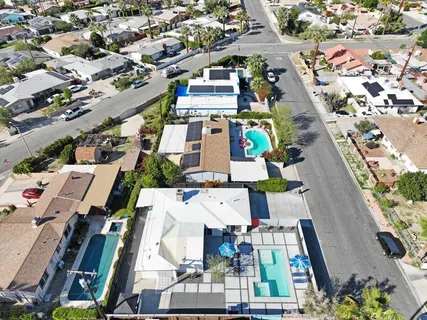 an aerial view of residential house with outdoor space and seating area