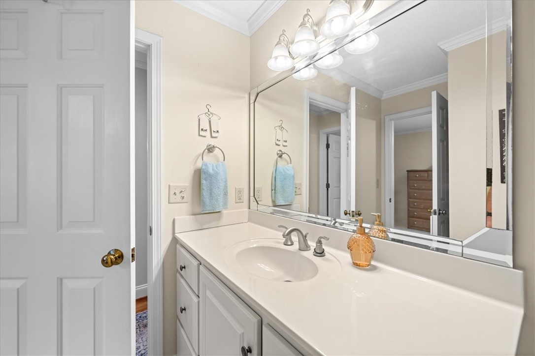 2004 Cardinal Park Drive Anderson, SC 29621 - Photo 30 of 40 Crisp crown molding accents the ceiling above a classic white vanity and expansive mirror.