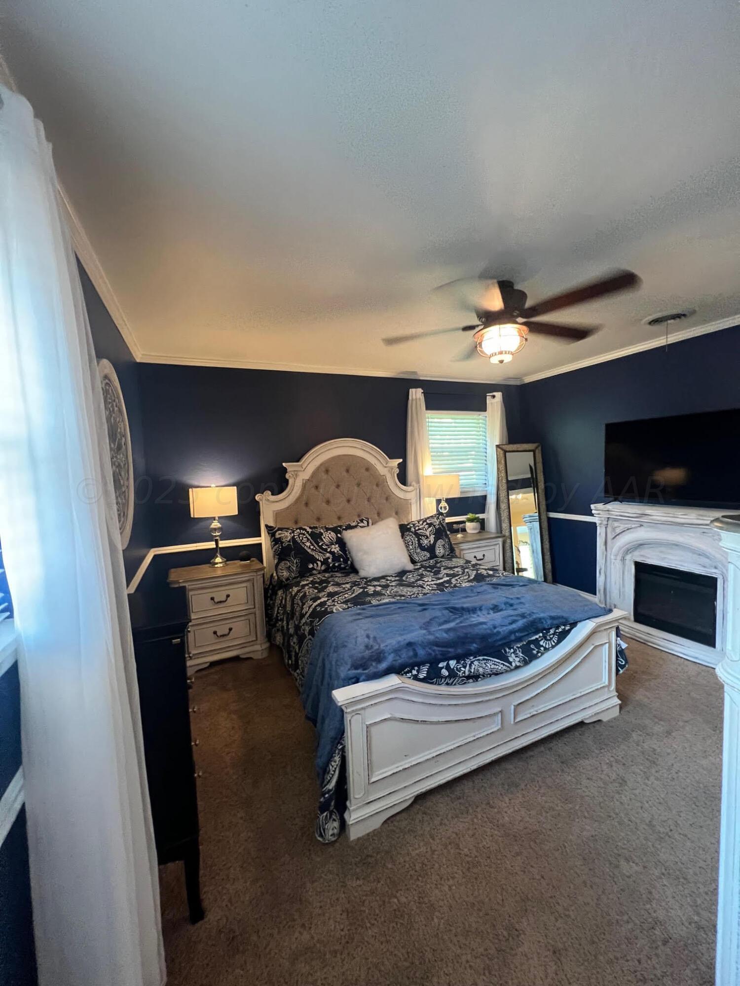 6213 Dreyfuss Road Amarillo, TX 79106 - Photo 17 of 27 a bed room with furniture and a fireplace