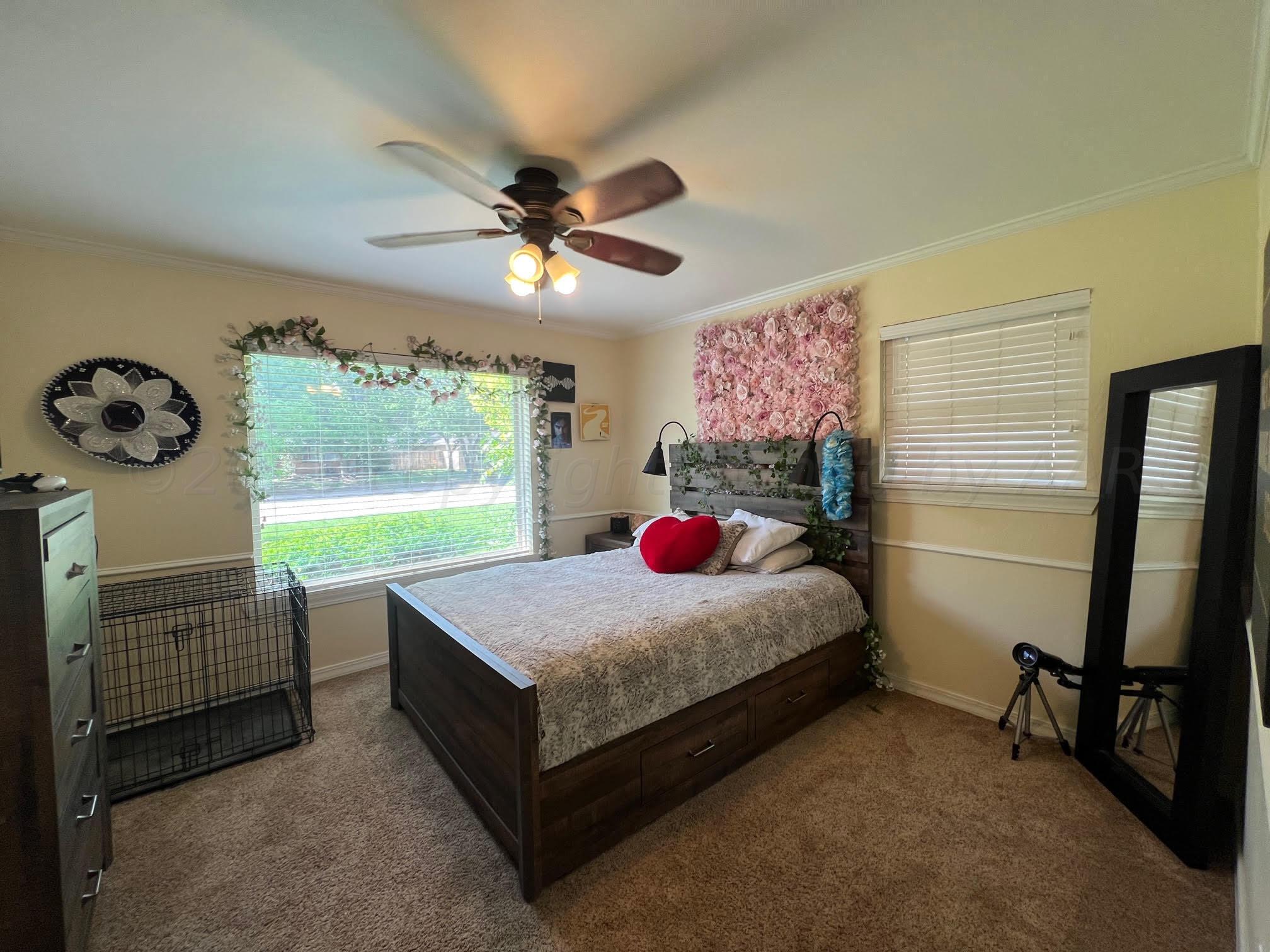 6213 Dreyfuss Road Amarillo, TX 79106 - Photo 23 of 27 a bedroom with a bed dresser and a window