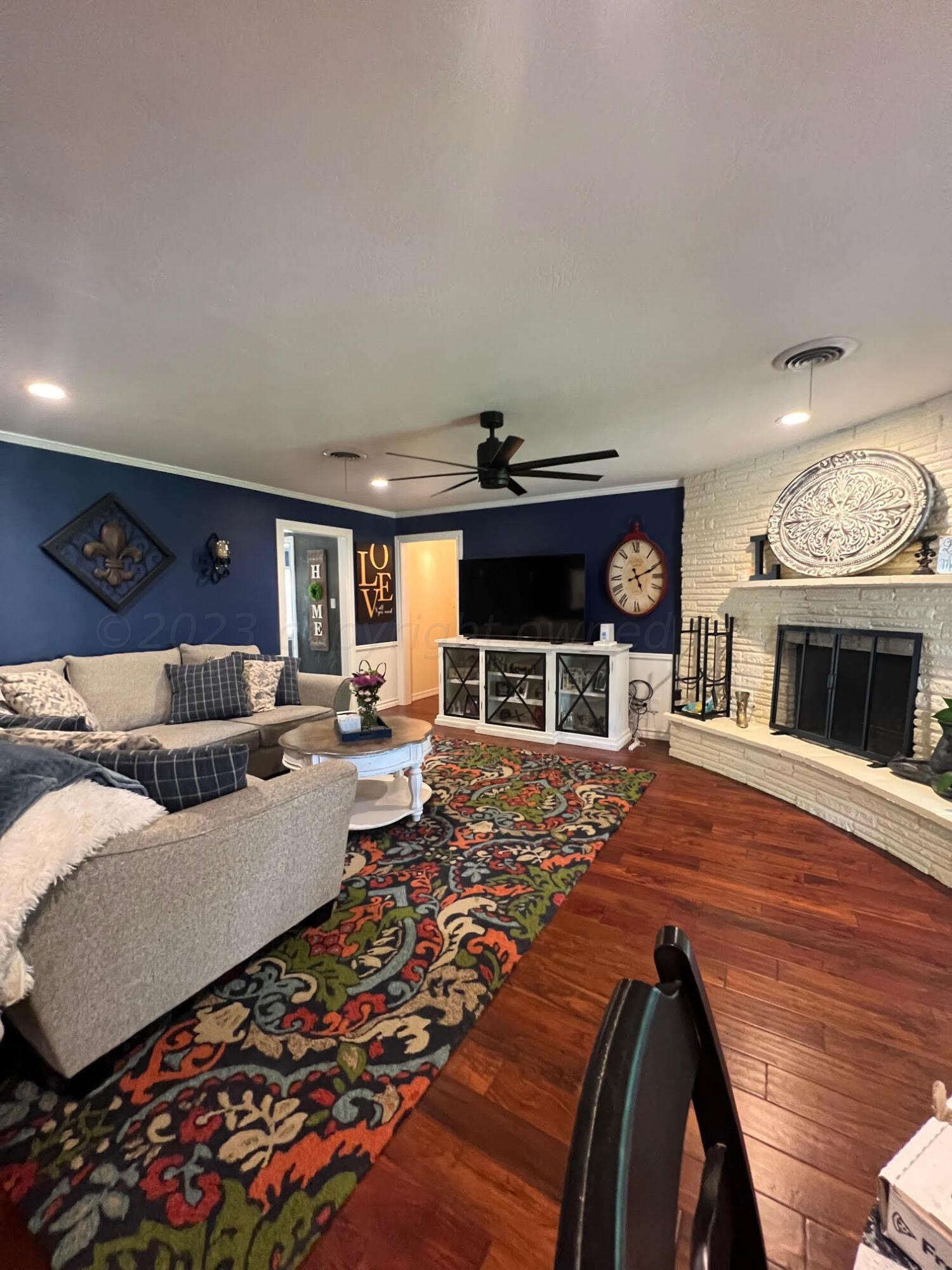 6213 Dreyfuss Road Amarillo, TX 79106 - Photo 6 of 27 a living room with furniture and a fireplace