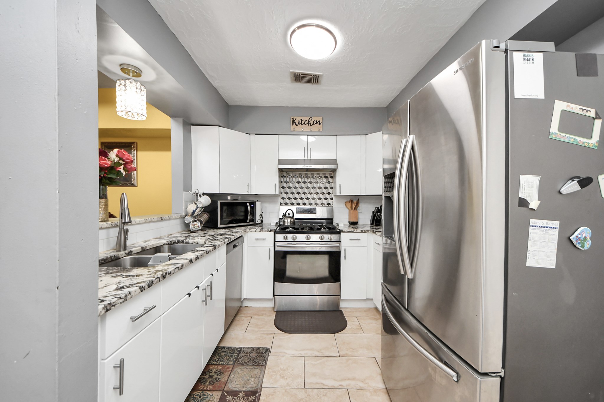 4155 Amir Street Houston, TX 77072 - Photo 18 of 43 a kitchen with stainless steel appliances a refrigerator sink and microwave