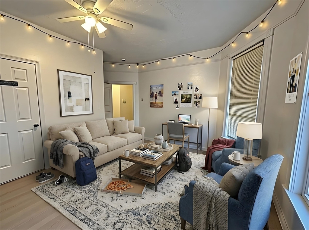 a living room with furniture and a chandelier